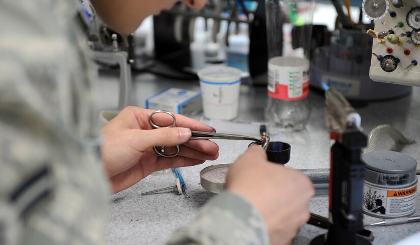 U.S. Air Force Airman 1st Class Cody Hagen, 633rd Dental Squadron dental lab technician, constructs dental fittings at Langley Air Force Base, Va., July 10, 2013.  Although the majority of cases the oral and maxillofacial surgeons at the clinic see are wisdom tooth extractions or dental implants, the facility is equipped to perform corrective jaw surgery, sleep apnea treatment and trauma care. (U.S. Air Force photo by Airman 1st Class Kimberly Nagle/Released)