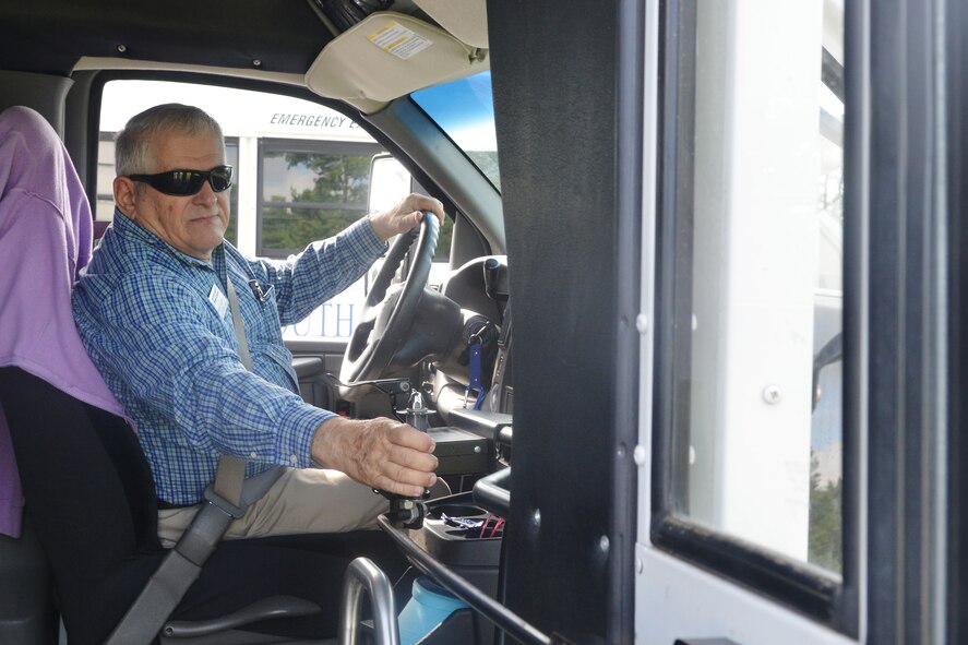 Larry Huff, 20th Medical Support Squadron American Red Cross station chairman, opens up the bus doors before picking children up from Woodland Pool, Shaw Air Force Base, S.C., July 16, 2013. Huff drove buses for the Sumter, S.C., school district for 21 years and volunteers as a Shaw Youth Center bus-driver. (U.S. Air Force photo by Airman 1st Class Ashley L. Gardner/Released)