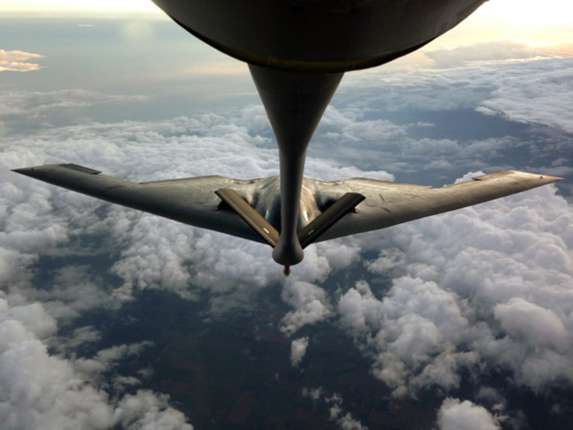 A B-2 Spirit assigned to the 509th Bomb Wing, Whiteman Air Force Base, Mo, closes in on the refueling boom of a KC-135 Stratotanker from McConnell Air Force Base, Kan., during an air refueling training mission, July 15, 2013.  The KC-135 was being operated by an aircrew from the Air Force Reserve 18th Air Refueling Squadron, 931st Air Refueling Group, at McConnell.  (U.S. Air Force photo by Senior Master Sgt. Ray Lewis)
