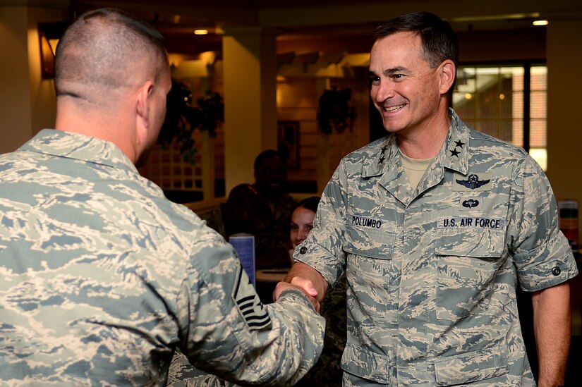 U.S. Air Force Maj. Gen. H.D. Polumbo Jr., 9th Air Force commander, meets a first sergeant during breakfast at the Crossbow Dining Facility at Langley Air Force Base, Va., July 16, 2013. During breakfast, Polumbo recognized four Airmen for their outstanding job performance and leadership skills by giving them his commander’s coin. (U.S. Air Force photo by Senior Airman Kayla Newman/Released)