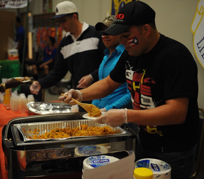 Airman 1st Class Jose Valle, 2nd Maintenance Squadron Fabrication Flight, prepares arroz-con gandules, a traditional Hispanic food, during Multicultural Day on Barksdale Air Force Base, La., July 12, 2013. Arroz-con gandules is made of rice and pigeon peas and is considered the national dish in Puerto Rico. (U.S. Air Force photo/Airman 1st Class Benjamin Gonsier)