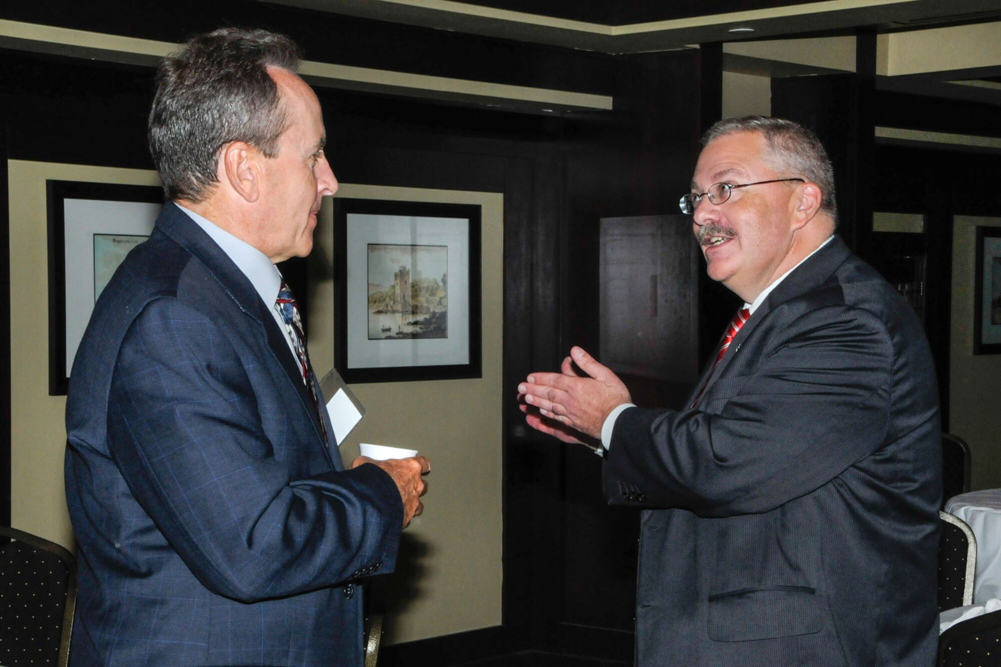 LEXINGTON, Mass. - Dr. Tim Rudolph (right), chief architect and chief technology officer for the Air Force Life Cycle Management Center, speaks with  Bob Verge from SAIC, during the Hanscom Representatives Association luncheon meeting July 11 at Waxy O'Connor's. Rudolph was the key speaker and discussed moving to a commoditized infrastructure. (U.S. Air Force photo by Linda LaBonte Britt)