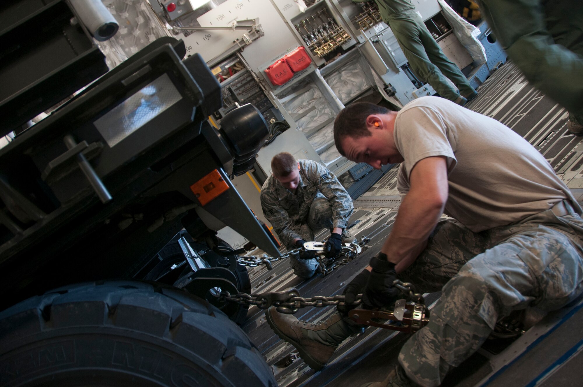 Niagara Falls Air Reserve Station, N.Y.— Airmen of the 30th Aerial Port Squadron secure an all-terrain forklift and a cargo-loader on a C-17 from McGuire Air Force Base, N.J. at the Niagara Falls Air Reserve Station, July 13, 2013.  The equipment and seven 30 APS Airmen will be stationed Ft. McCoy, Wisconsin in support of a Warrior Exercise, known as WAREX, slated to take place this month. The WAREX is a joint military training exercise for future contingency missions by ensuring proficiency in both technical and tactical skills. The 30th APS has been supporting WAREX and Global Medic since 2009. (U.S. Air Force Photo by Tech. Sgt. Andrew Caya)