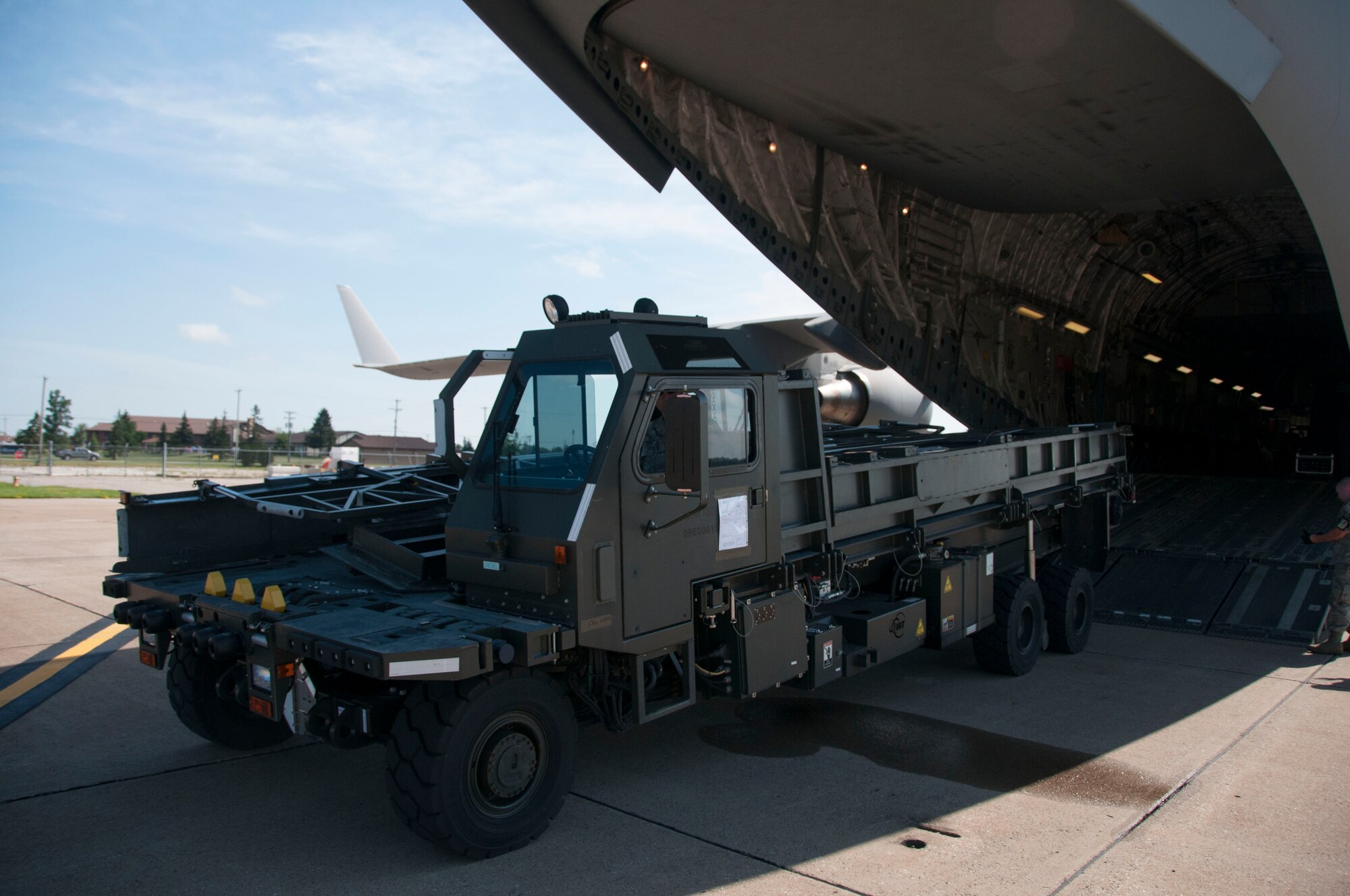 Niagara Falls Air Reserve Station, N.Y.— Airmen of the 30th Aerial Port Squadron upload  a cargo-loader on a C-17 from McGuire Air Force Base, N.J.  at the Niagara Falls Air Reserve Station, July 13, 2013.  The equipment and seven 30 APS Airmen will be stationed Ft. McCoy, Wisconsin in support of a Warrior Exercise, known as WAREX, slated to take place this month. The WAREX is a joint military training exercise for future contingency missions by ensuring proficiency in both technical and tactical skills. The 30th APS has been supporting WAREX and Global Medic since 2009. (U.S. Air Force Photo by Tech. Sgt. Andrew Caya)