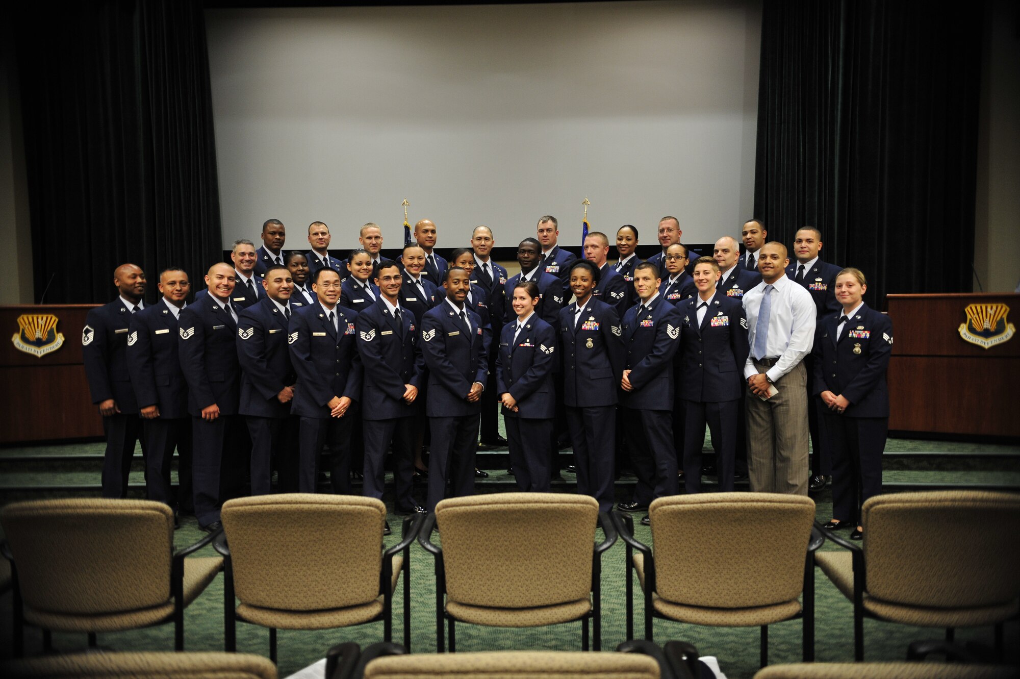 MacDill Air Force Base’s Community College of the Air Force recipients pause after practice for a group photo, May 23, 2013 at MacDill Air Force Base, Fla. The Air Force emphasizes education and encourages Airmen to get their CCAF degrees in their respective career fields. (U.S. Air Force photo by Airman 1st Class Sarah Breer/Released)