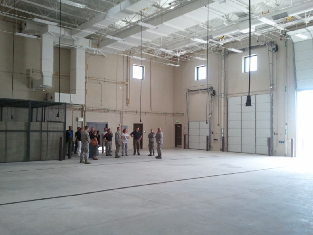 PETERSON AIR FORCE BASE, Colo. – Lt. Col. Mark Guerber (far right), 16th Space Control Squadron commander, gives a tour of the building 2027 maintenance bay June 28. Building 2027 is the new home to the 16th SPCS and its Reserve Associate Unit, the 380th SPCS. (U.S. Air Force photo/Steve Brady)