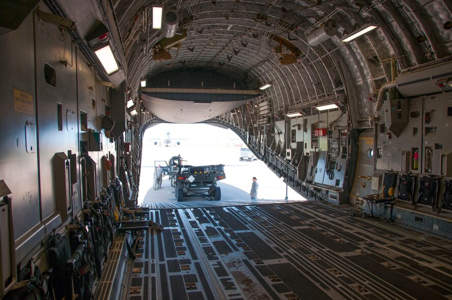 Niagara Falls Air Reserve Station, N.Y.— Airmen of the 30th Aerial Port Squadron upload a cargo-loader on a C-17 from McGuire Air Force Base, N.J.  at the Niagara Falls Air Reserve Station, July 13, 2013.  The equipment and seven 30 APS Airmen will be stationed Ft. McCoy, Wisconsin in support of a Warrior Exercise, known as WAREX, slated to take place this month. The WAREX is a joint military training exercise for future contingency missions by ensuring proficiency in both technical and tactical skills. The 30th APS has been supporting WAREX and Global Medic since 2009. (U.S. Air Force Photo by Tech. Sgt. Andrew Caya)