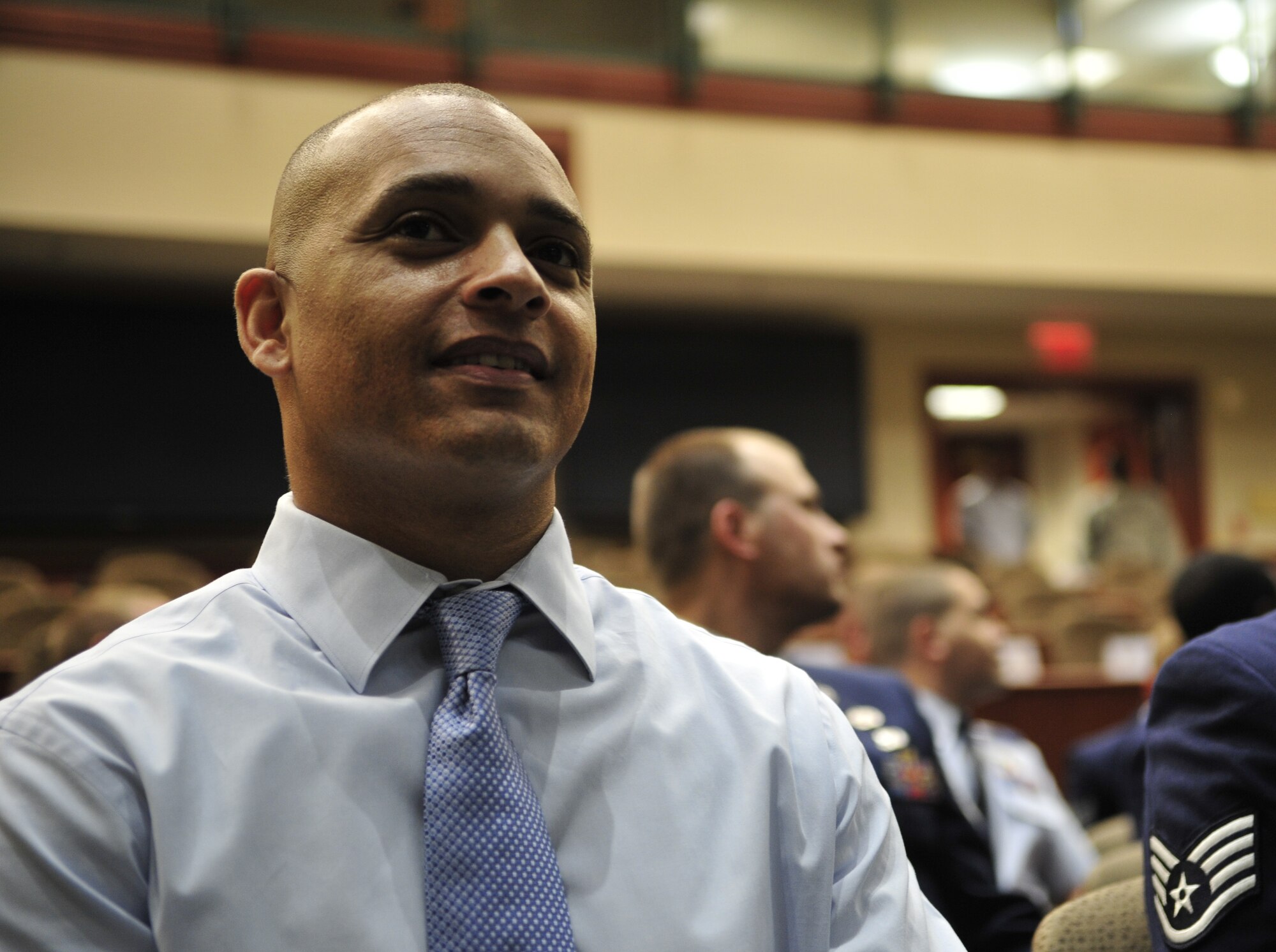 Retired Staff Sgt. Jason Ellis, former command post technician, listens to a speaker before he receives his Community College of the Air Force associate’s degree in emergency management May 23, 2013 at MacDill Air Force Base, Fla. Ellis was the first wounded warrior to receive a CCAF through the Wounded Warrior Program. (U.S. Air Force photo by Airman 1st Class Sarah Breer/Released)
