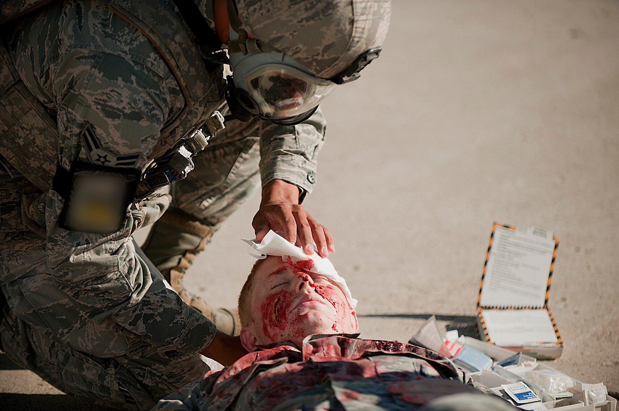 Airmen from the 5th Bomb Wing participate in a mass causality exercise at Minot Air Force Base, N.D., June 27, 2013. The purpose of the exercise is to evaluate and validate the 5th BW’s emergency management capabilities and testing first responders and medical personnel on their ability to quickly and effectively respond to a catastrophic event.  (U.S. Air Force photos/Airman 1st Class Kristoffer Kaubisch)