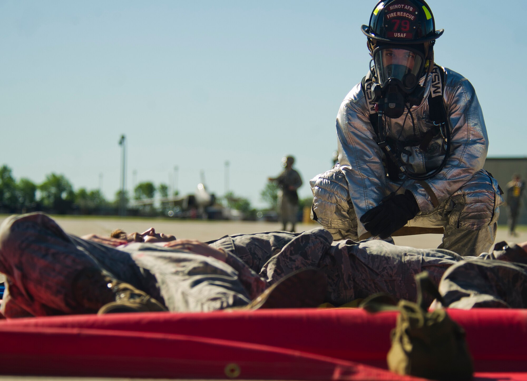 Airmen from the 5th Bomb Wing participate in a mass causality exercise at Minot Air Force Base, N.D., June 27, 2013. The purpose of the exercise is to evaluate and validate the 5th BW’s emergency management capabilities and testing first responders and medical personnel on their ability to quickly and effectively respond to a catastrophic event.  (U.S. Air Force photos/Senior Airman Brittany Y. Auld)