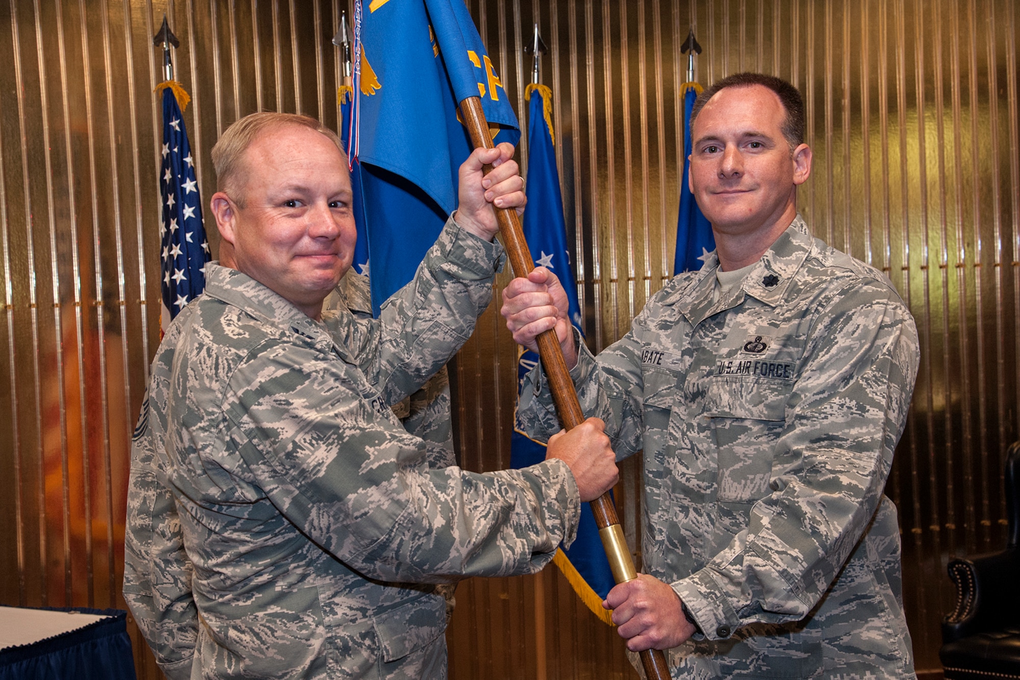 PETERSON AIR FORCE BASE, Colo. – Col. Chris Crawford, 21st Space Wing commander, passes the 21st Comptroller Squadron flag to Lt. Col. Christopher C. Abate during the 21st CPTS change of command ceremony July 8 at The Club.  As the 21st CPTS commander, Abate will be the senior financial advisor to the 21st Space Wing commander, and is responsible for the management, control and execution of the Wing’s annual operating budget and for providing $1.8 billion of accounting support across Team Pete annually. Abate replaces outgoing commander Col. William Marrs. (U.S. Air Force photo/Craig Denton)