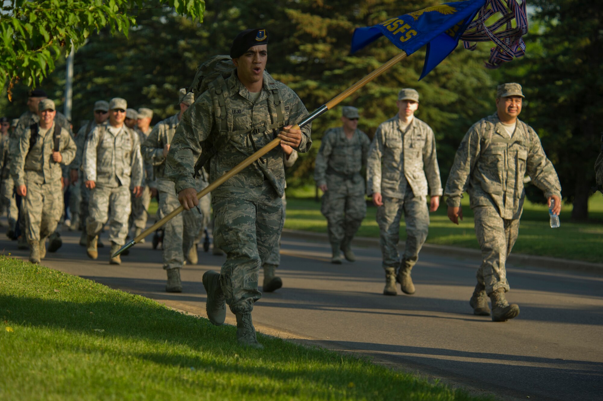 Members of the 91st Missile Wing and family members participate in a three-mile ruck march at Minot Air Force Base, N.D., July 3, 2013. Before the march, Col. Robert Vercher, 91st MW commander, held an all-call and spoke to Airmen and their family members about the 101 Critical Days of Summer. (U.S. Air Force photo/Senior Brittany Y. Auld)