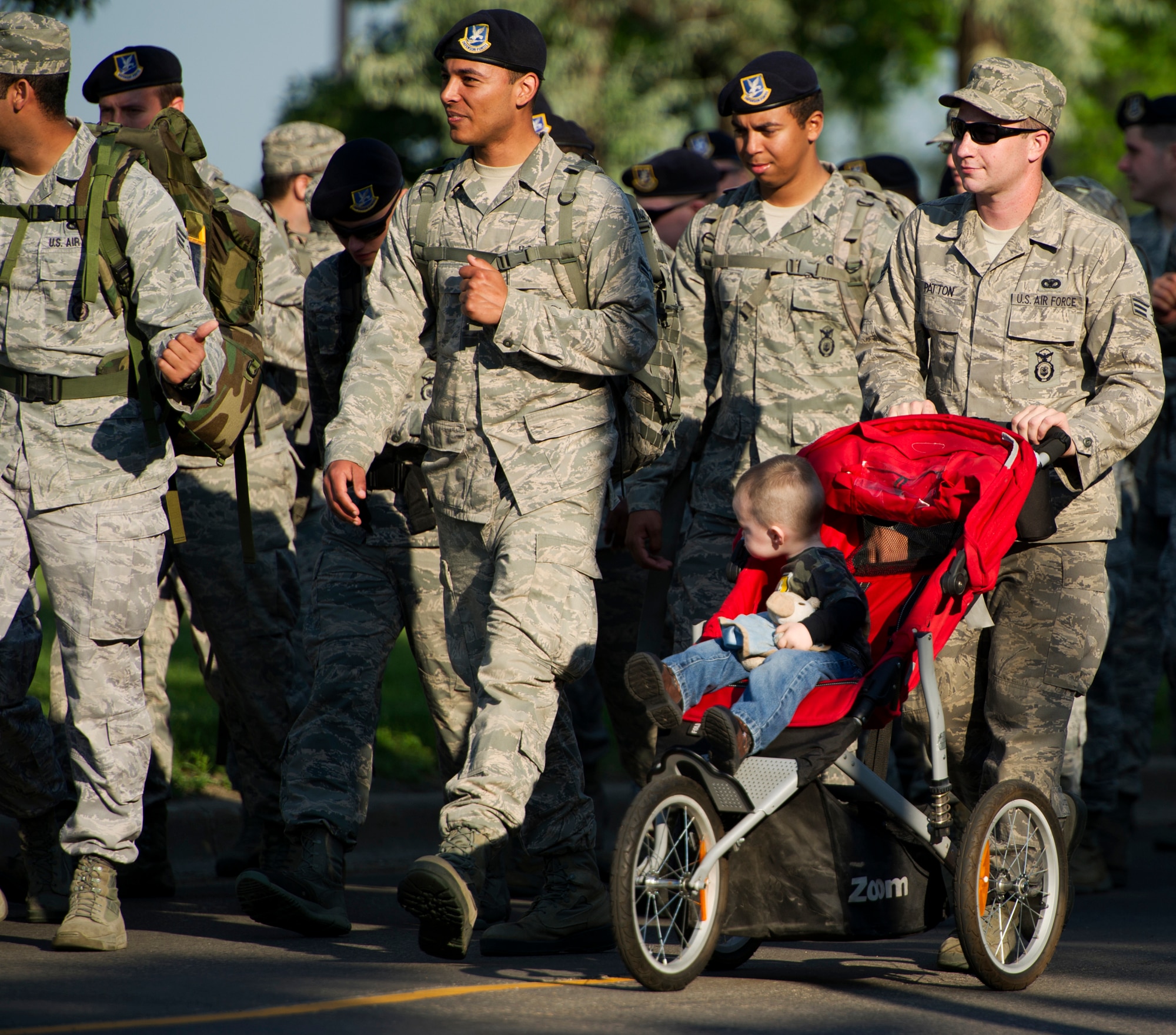 Members of the 91st Missile Wing and family members participate in a three-mile ruck march at Minot Air Force Base, N.D., July 3, 2013. Before the march, Col. Robert Vercher, 91st MW commander, held an all-call and spoke to Airmen and their family members about the 101 Critical Days of Summer.  (U.S. Air Force photo/Airman 1st Class Kristoffer Kaubisch)