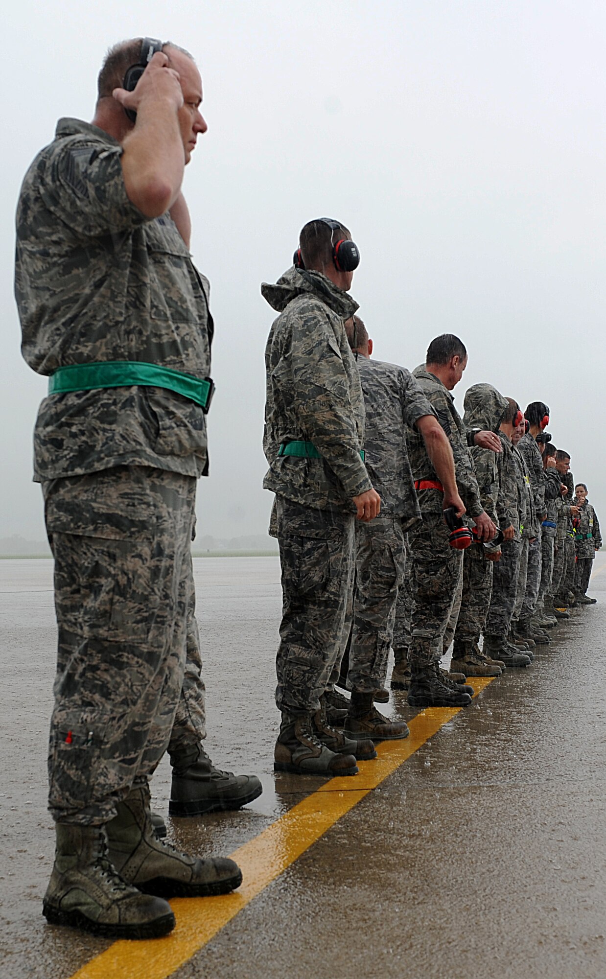 Airmen of the 1st Fighter Wing, line the runway to greet Col. Kevin J. Robbins, 1st Fighter Wing commander, after the completion of his “fini flight” at Langley Air Force Base, Va., July 12, 2013. As Commander, Robbins was responsible for the worldwide rapid deployment and employment of F-22s. (U.S. Air Force photo by Airman 1st Class Kimberly Nagle/Released) 