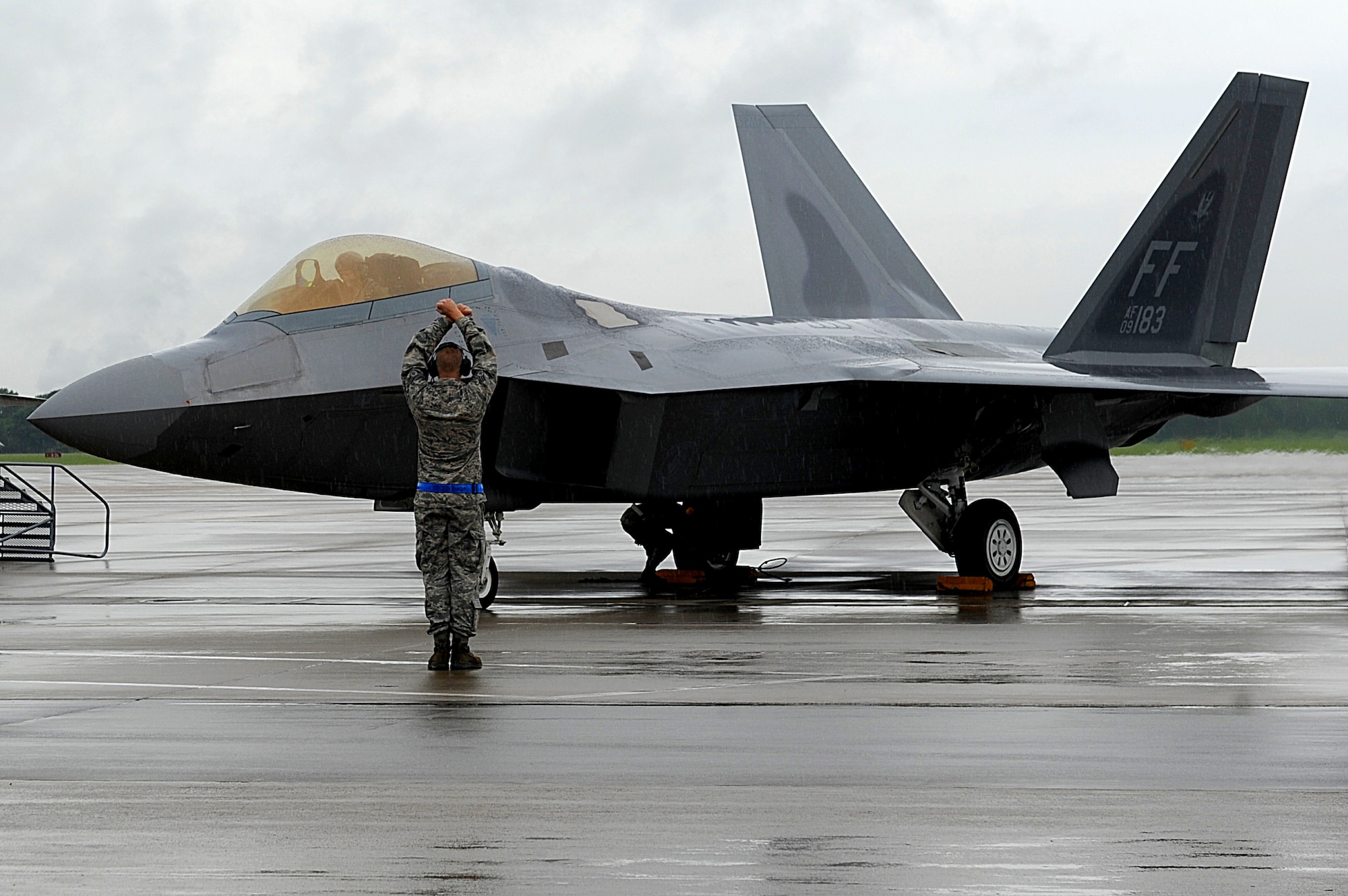 A 1st Fighter Wing Airman prepares Col. Kevin J. Robbins, 1st FW commander, for his “fini flight” at Langley Air Force Base, Va., July 12, 2013.  During his career, Robbins flew more than 250 combat hours. (U.S. Air Force photo by Airman 1st Class Kimberly Nagle/Released)