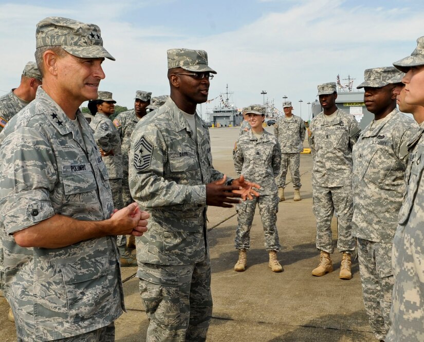 From left, U.S. Air Force Maj. Gen. H.D. Polumbo Jr., 9th Air Force commander, and Chief Master Sgt. James Davis, 9th Air Force command chief, talk with Soldiers from 833rd Transportation Battalion prior to touring one of their tug boats at Fort Eustis, Va., July 16, 2013. In addition to touring the boats, Polumbo and Davis visited Felker Army Air Field and the Fort Eustis Club during their visit. (U.S. Air Force photo by Staff Sgt. Wesley Farnsworth/Released)

