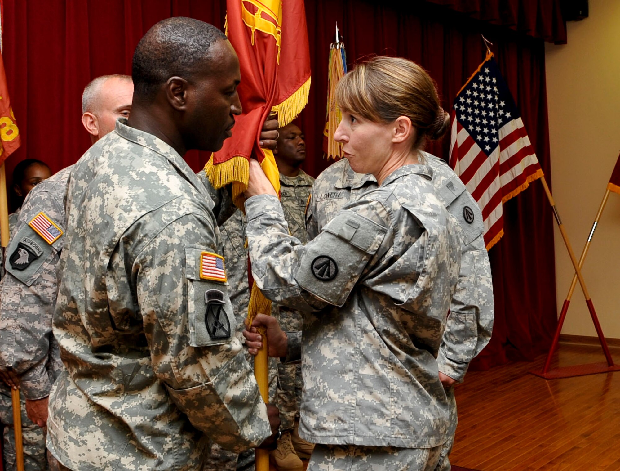 (From left) U.S. Army Sgt. Maj. Johnny Dees, incoming 833rd Transportation Battalion command sergeant major, accepts the battalion colors from U.S. Army Lt. Col. Isabel Geiger, 833rd Transportation Battalion commander, during the assumption of responsibility ceremony at Fort Eustis, Va., July 15, 2013. Dees assumed the role of command sergeant major from U.S. Army Master Sgt. David Lowery. (U.S. Air Force photo by Staff Sgt. Wesley Farnsworth/Released)

