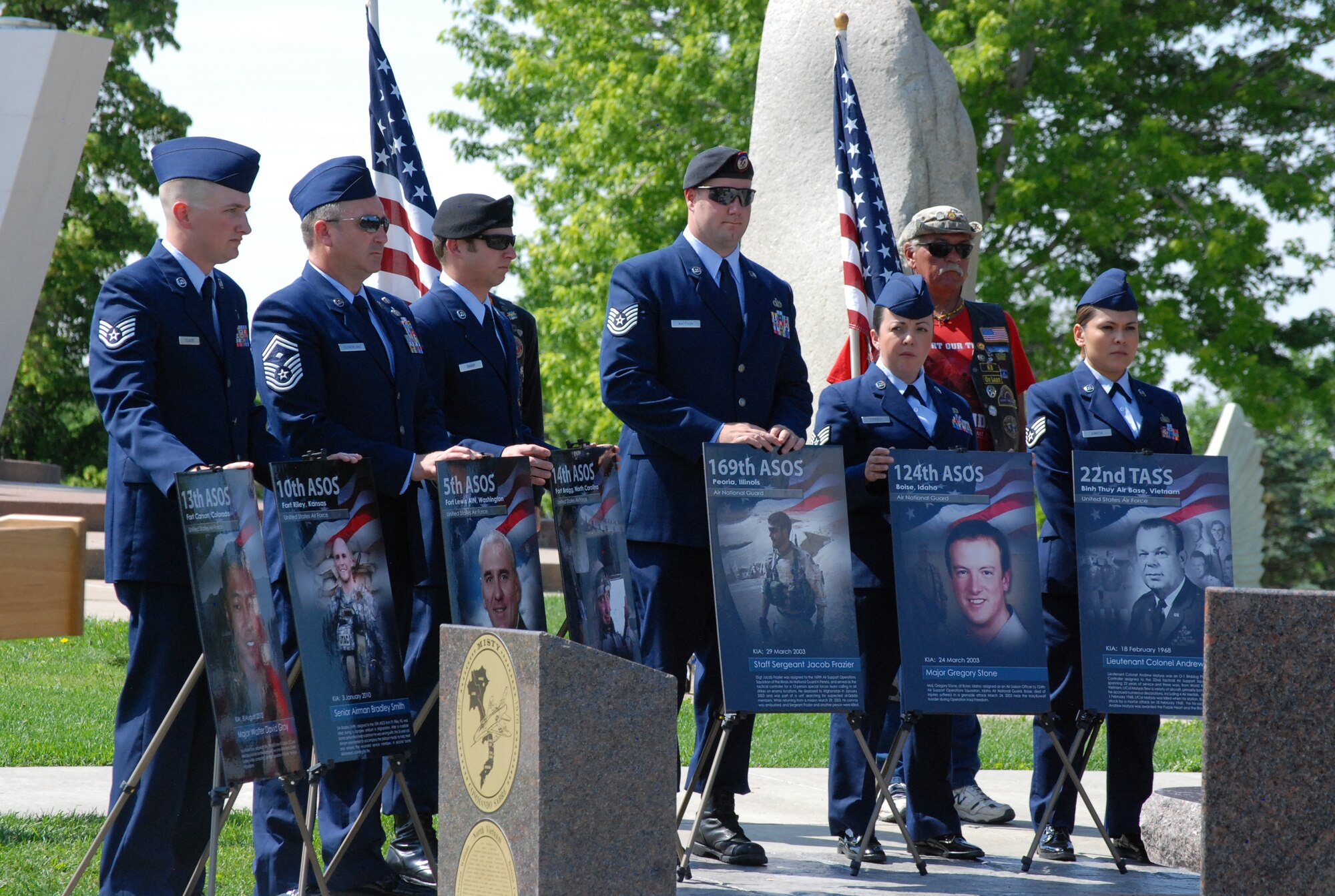 COLORADO SPRINGS, Colo. – Airmen from the 13th ASOS at Fort Carson hold photos of the fallen service members being honored at the unveiling of the new TACP Memorial July 5. The memorial is located within the Forward Air Controller portion of the Colorado Springs Memorial Park Veteran's Memorial. (U.S. Air Force photo/Michael Golembesky)