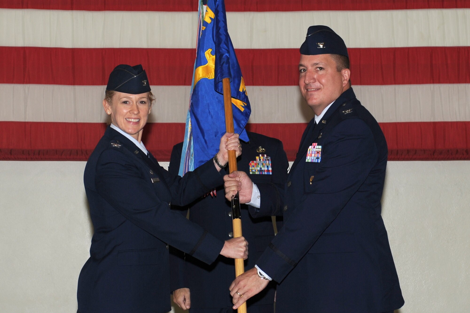 GOODFELLOW AIR FORCE BASE, Texas -- Col. Kimberlee Joos, 17th Training Wing Commander, passes the 17th Mission Support Group guidon to the incoming commander, Col. Dominic Bernardi III, during the Change of Command ceremony, July 15. The change of command ceremony is steeped in tradition and allows units to witness the formal command transfer from one officer to another.  (U.S. Air Force photo by Staff Sgt. Laura R. McFarlane)