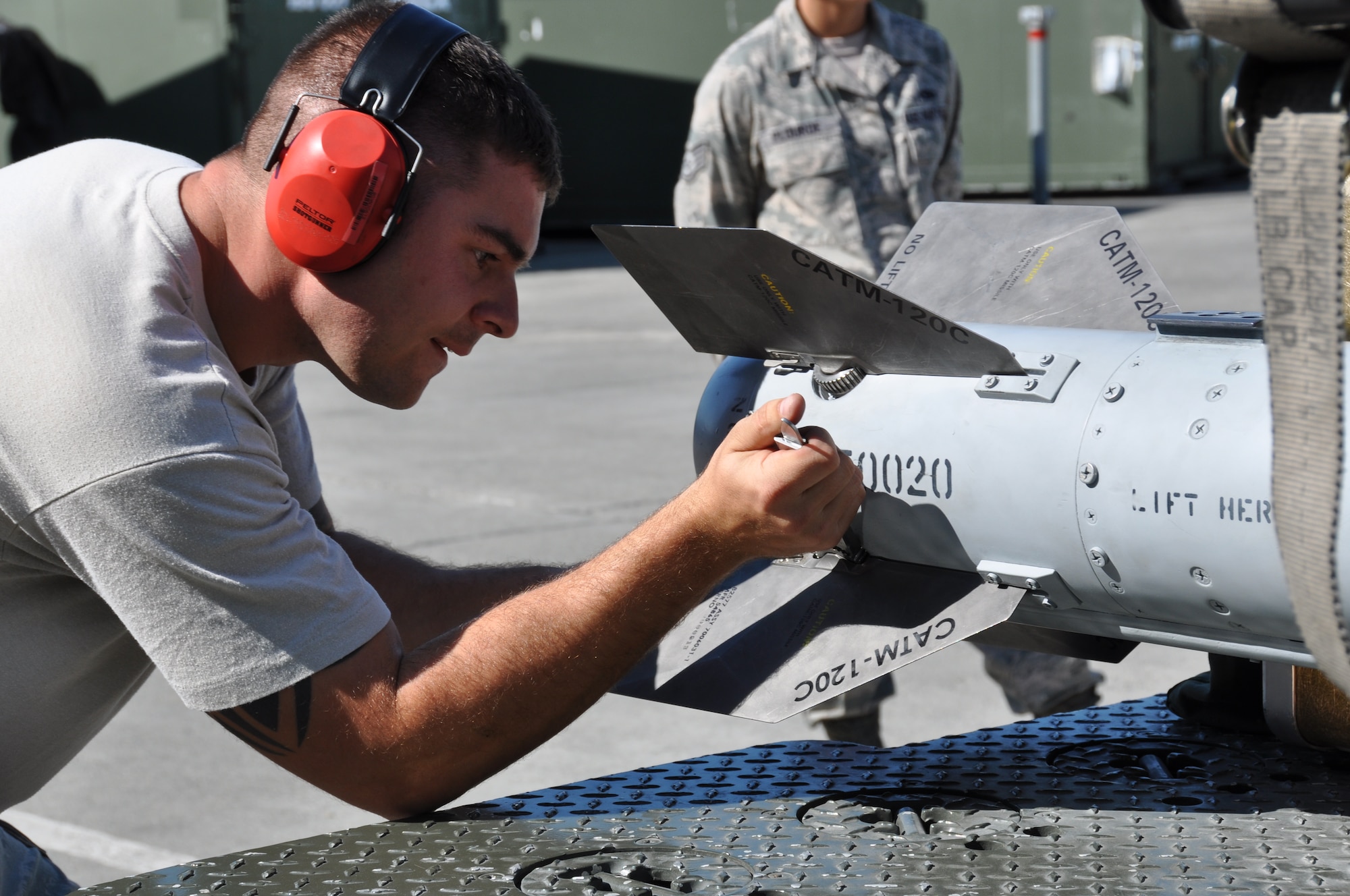 Staff Sgt. Adam Ducharme, 477th Aircraft Maintenance Squadron, installs stabilizing fins on to the AIM-120 air-to-air missile during the quarterly load crew competition here July 12. Three teams from the active duty 525th and 90th AMUs and the Reserve 477th AMXS participated in the load crew competition.  The 525th AMU load crew team placed first in the event. (U.S. Air Force/Capt. Ashley Conner)  