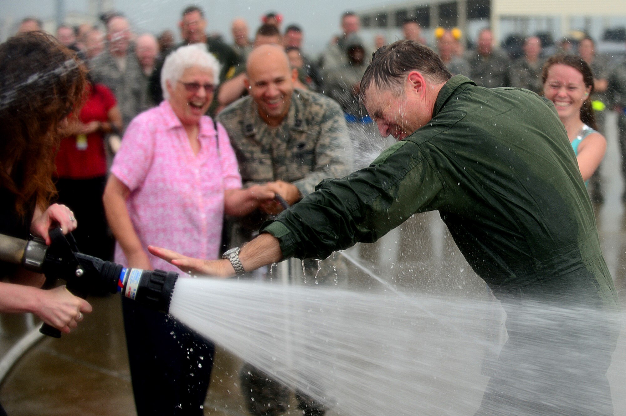 U.S. Air Force Col. Kevin J. Robbins, 1st Fighter Wing commander, is hosed down by his wife and family as he completes his “fini flight” at Langley Air Force Base, Va., July 12, 2013. Immediately following his “fini flight,” Robbins retired as commander of the 1st FW. (U.S. Air Force photo by Senior Airman Kayla Newman/Released)