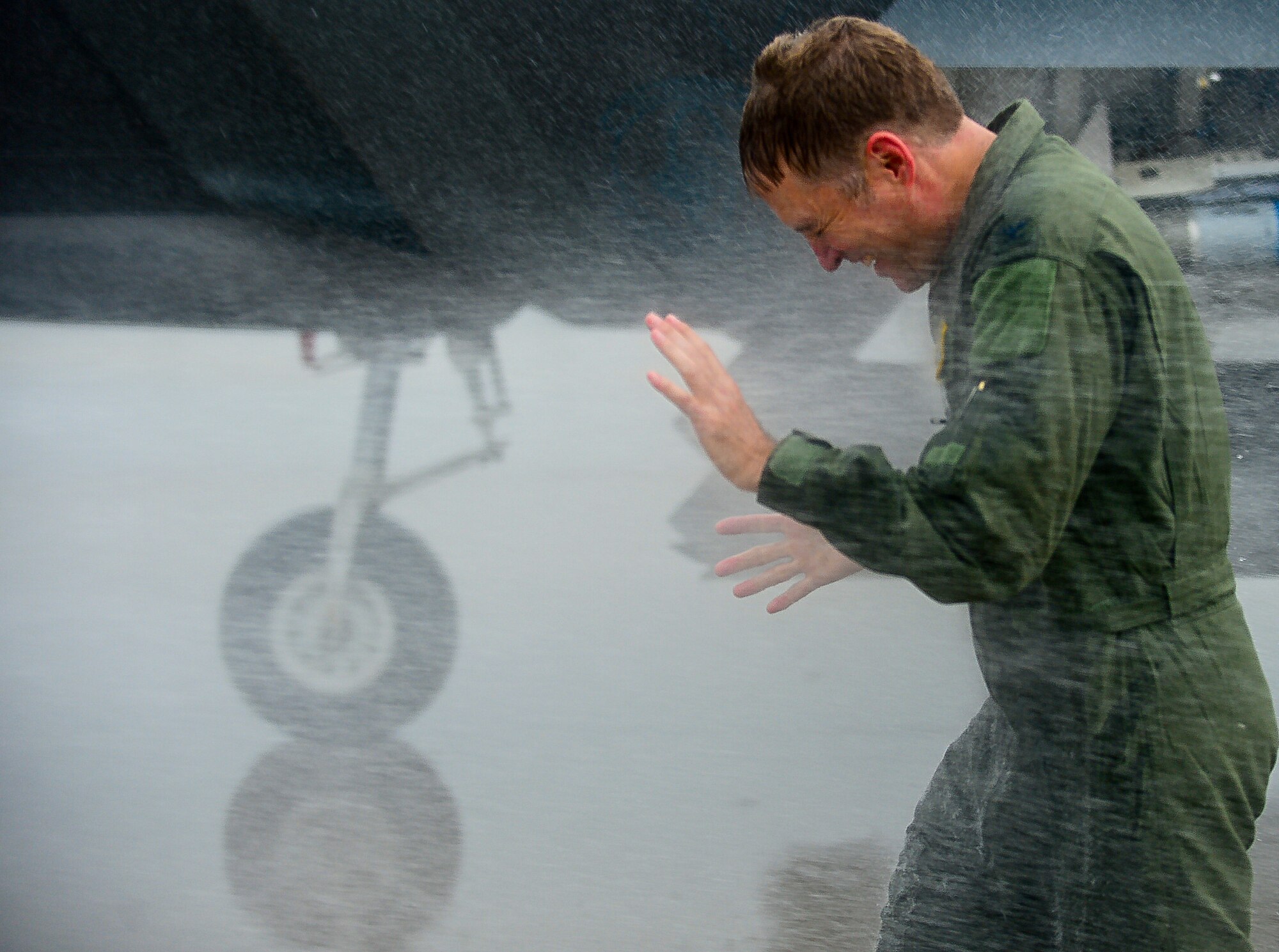U.S. Air Force Col. Kevin J. Robbins, 1st Fighter Wing commander, is hosed down by his wife and family as he completes his “fini flight” at Langley Air Force Base, Va., July 12, 2013. Immediately following his “fini flight,” Robbins retired as commander of the 1st FW. (U.S. Air Force photo by Senior Airman Kayla Newman/Released)
