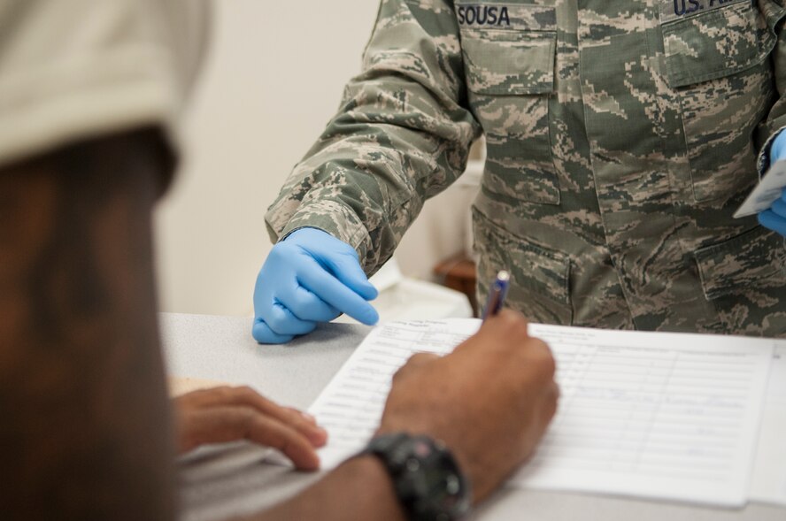 U.S. Air Force Airman 1st Class Terry Jones, 822d Base Defense Squadron fireteam member, initials a document to verify his identity June 26, 2013, at Moody Air Force Base, Ga. The Drug Demand Reduction Program tests Airmen for drugs at random six days a week. (U.S. Air Force photo by Sandra L. Marrero/Released)
