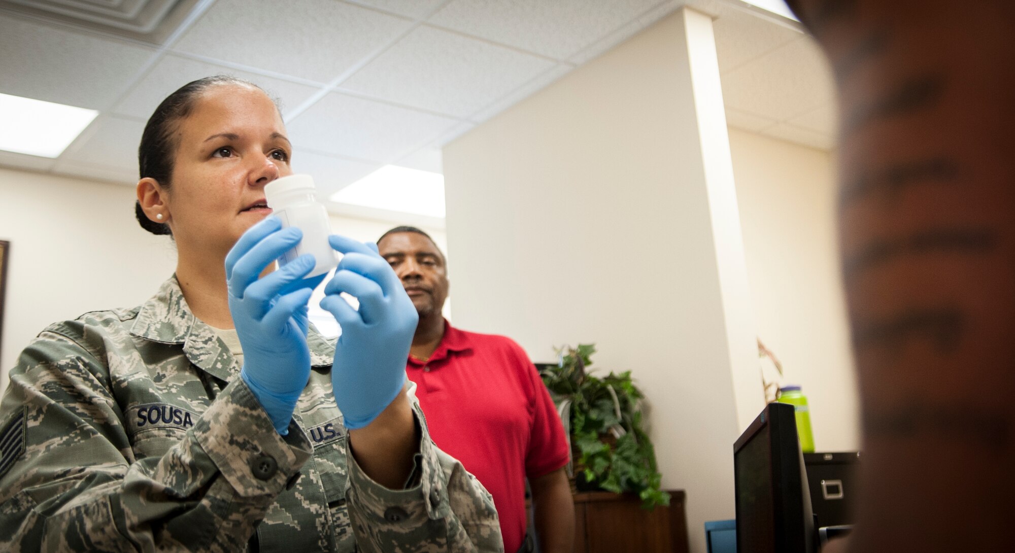 U.S. Air Force Tech. Sgt. Kimber Sousa, 23d Medical Group drug testing program administrator, briefs an Airman about how to provide a sample for drug testing at Moody Air Force Base, Ga., June 26, 2013. The Drug Demand Reduction Program is a Department of Defense initiative committed to eradicating employee drug abuse. (U.S. Air Force photo by Sandra L. Marrero/Released) 
