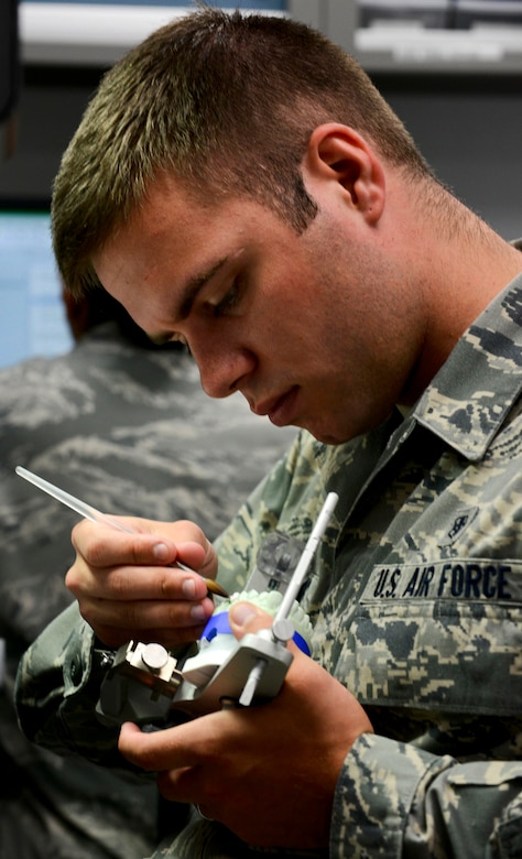 U.S. Air Force Airman 1st Class Jonathan Thornburg, 633rd Dental Squadron laboratory technician, inspects a patient’s dental mold at Langley Air Force Base, Va., July 10, 2013. As part of an initiative to improve patient care, the clinic recently completed renovations which include new patient rooms and state-of-the-art tools, such as silent electric hand tools and dental lasers. (U.S. Air Force photo by Airman 1st Class R. Alex Durbin/Released)