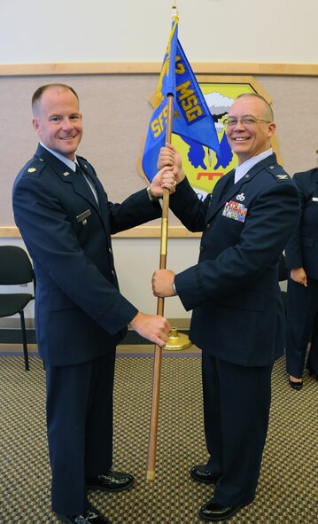 Col. Jeffery Barnett (on right), 442nd Mission Support Group commander, hands off the 442nd Security Forces Squadron guidon to Maj. Layne Wroblewski, 442nd SFS commander, during a change of command ceremony here on July 14. Wroblewski took over command of the unit from retiring 442nd SFS Commander Maj. Dan Diercks. The 442nd SFS is part of the 442nd Fighter Wing, an Air Force Reserve A-10 Thunderbolt II unit at Whiteman AFB, Mo. (U.S. Air Force photo/Senior Airman Mike Addis)