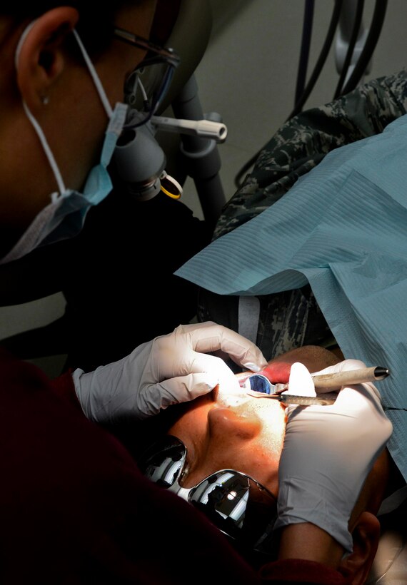 A U.S. Air Force dentist performs an examination on a patient at the 633rd Dental Squadron clinic at Langley Air Force Base, Va., July 11, 2013. According to the Centers for Disease Control and Prevention, 23.7 percent of adults between the ages of 20 and 64 have untreated cavities. Most are avoidable, and the clinic recommends Service members brush and floss twice daily and decrease snacking and sipping acidic drinks such as energy drinks and soda. (U.S. Air Force photo by Airman 1st Class R. Alex Durbin/Released)