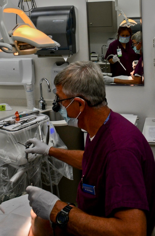 A U.S. Air Force dentist performs an examination on a patient at the 633rd Dental Squadron clinic at Langley Air Force Base, Va., July 11, 2013. The squadron is comprised of four flights totaling 25 dentists and 60 ancillary staff that provide a range of services, including general dentistry, prosthodontics, periodontics, orthodontics, endodontics and oral and maxillofacial surgery. (U.S. Air Force photo by Airman 1st Class R. Alex Durbin/Released)