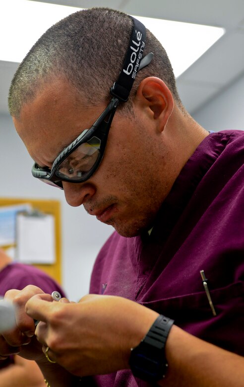 U.S. Air Force Senior Airman Jordan Barragan, 633rd Dental Squadron laboratory technician, uses tools to make a crown at the dental clinic at Langley Air Force Base, Va., July 10, 2013. Due to its range of specialties, the clinic provides most care in-house and does not refer patients to off-base care providers, saving them time and money. (U.S. Air Force photo by Airman 1st Class R. Alex Durbin/Released)