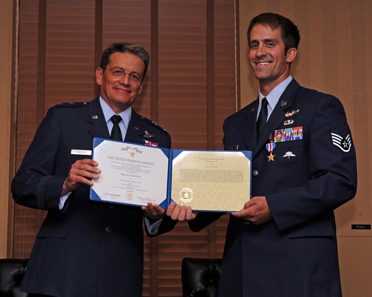 U.S. Air Force Maj. Gen. Frank Padilla, Deputy Inspector General of the Air Force, presents Staff Sgt. Zachary Kline, 306th Rescue Squadron pararescueman with the Silver Star citation during a ceremony at Davis-Monthan Air Force Base, Ariz., July 14, 2013. (U.S. Air Force photo by Senior Airman Christine Griffiths/Released) 