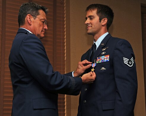 Maj. Gen. Frank Padilla pins a Silver Star on Staff Sgt. Zachary during a ceremony July 14, 2013, at Davis-Monthan Air Force Base, Ariz. Kline earned the medal while serving in Afghanistan April 23, 2011. Padilla is the deputy inspector general of the Air Force, and Kline is a 306th Rescue Squadron pararescueman. (U.S. Air Force photo/Senior Airman Christine Griffiths) 