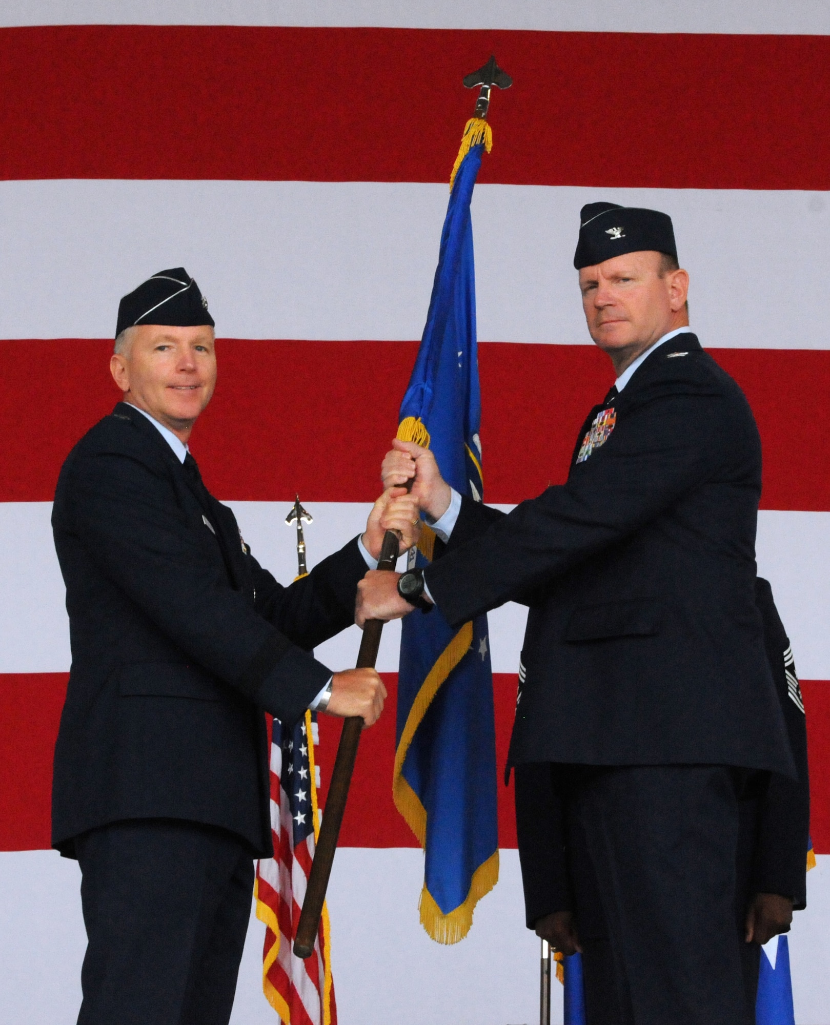 Maj. Gen. William B. Binger (left), 10th Air Force commander, passes the 482nd Fighter Wing guidon to Col. Christian G. Funk, new 482nd Fighter Wing commander, during the 482nd FW change of command ceremony at Homestead Air Reserve Base, Fla., July 14. (U.S. Air Force photo/Senior Airman Jaimi Upthegrove)