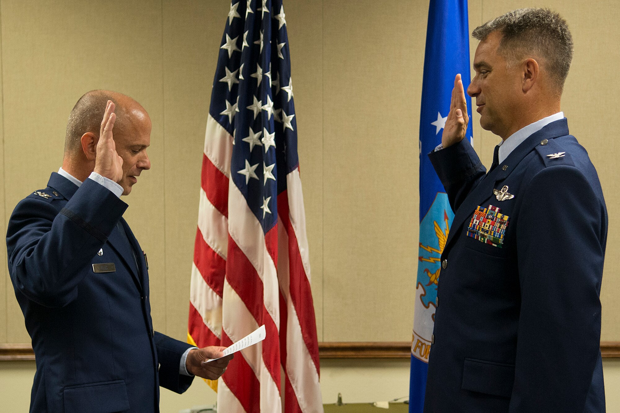 U.S. Air Force Col. Dave Leedom, right, recites the oath given by Col. Jonathan Ellis, 307th Bomb Wing commander, during a Pinning On ceremony, July 12, 2013, Barksdale Air Force Base, La. Leedom is a B-52 pilot and the former commander of the 93rd Bomb Squadron and a B-52 pilot. (U.S. Air Force photo by Master Sgt. Greg Steele/Released)