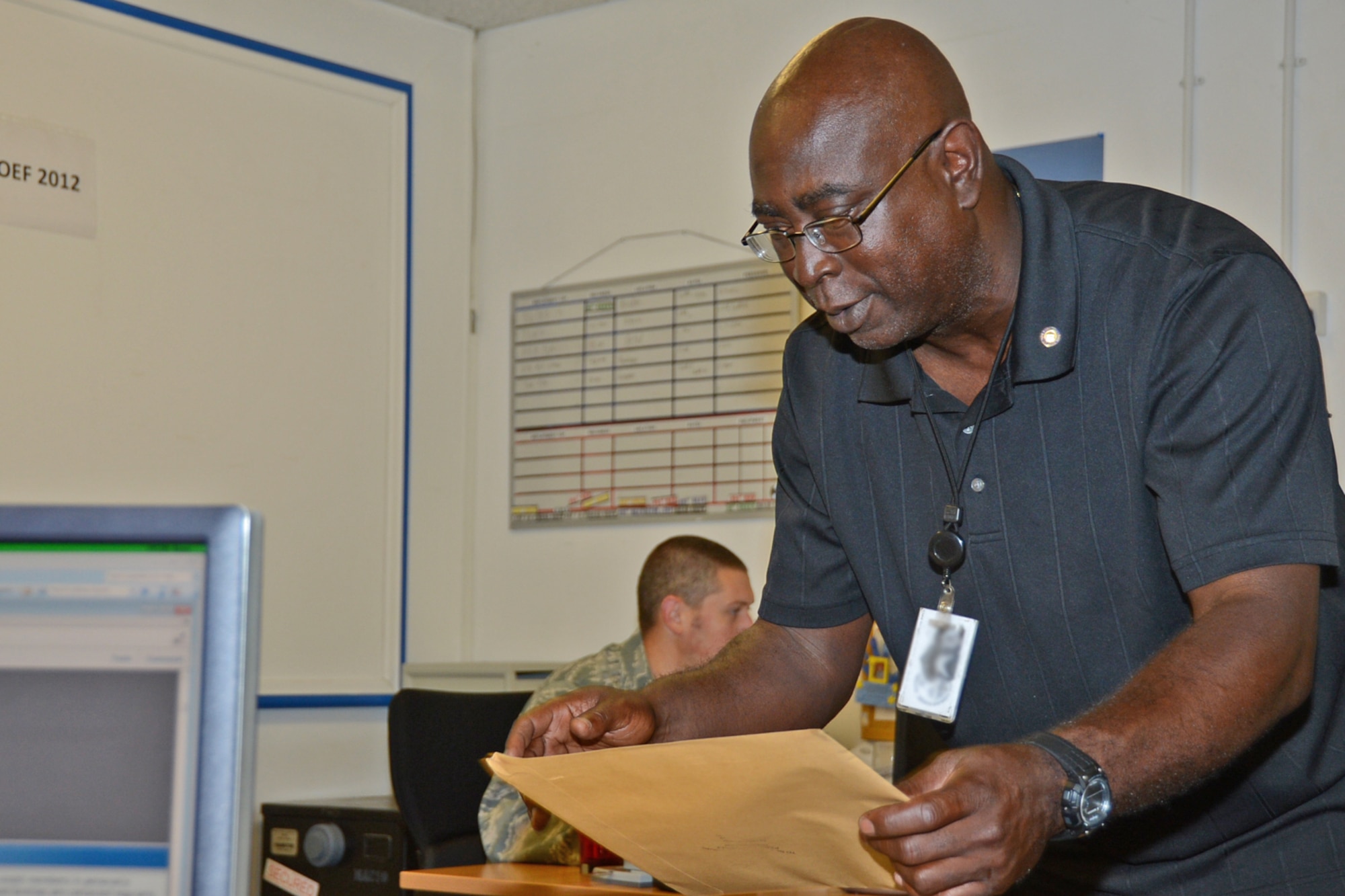 ROYAL AIR FORCE LAKENHEATH, England – Anthony Meggett, 48th Component Maintenance Squadron unit deployment manager, files through personnel packets July 16, 2013. Meggett was nominated for a Liberty Spotlight because he displays the core value of “Excellence in All We Do.” (U.S. Air Force photo by Airman 1st Class Trevor T. McBride) 