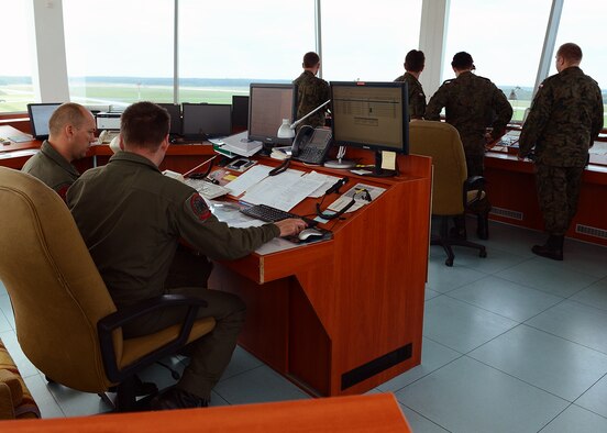 LASK AIR BASE, Poland -- Members of the Polish air traffic control tower coordinate flying operations July 16, 2013. Poland and the United States continue to strengthen their military interoperability through continued partnerships, such as the aviation detachment's training sessions. (U.S. Air Force photo by Staff Sgt. Daryl Knee/Released)