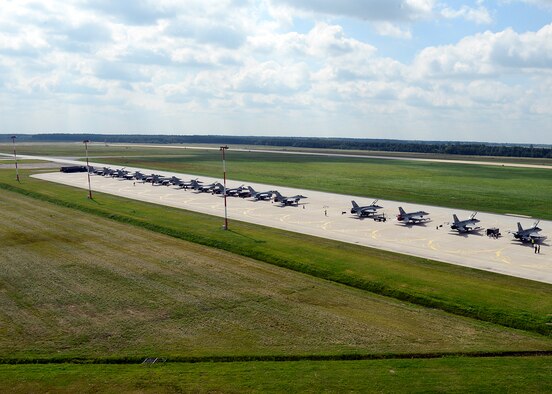 LASK AIR BASE, Poland -- A line of Polish air force F-16 Fighting Falcon fighter aircraft line the taxiway here July 16, 2013. The U.S. and Polish air forces flew two training missions today as part of a two-week partnership building effort. (U.S. Air Force photo by Staff Sgt. Daryl Knee/Released)