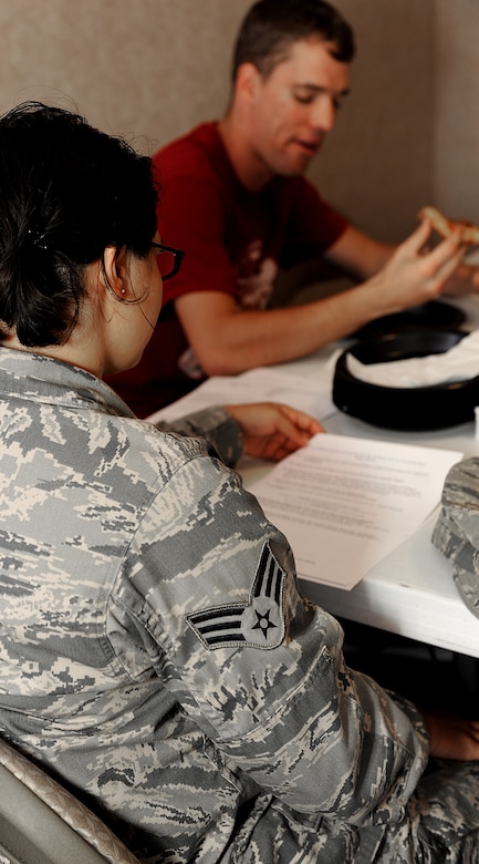 Senior Airman Felecia Figueroa, 440th Supply Chain Operations Squadron computer operations journeyman, reads over a discussion outline at the Langley Chapel Single Airmen Ministry meeting at Langley Air Force Base, Va., July 9, 2013. The LCSAM helps support the morale and spiritual lives of Airmen living in the dormitories. (U.S. Air Force photo by Airman 1st Class Kimberly Nagle/Released)