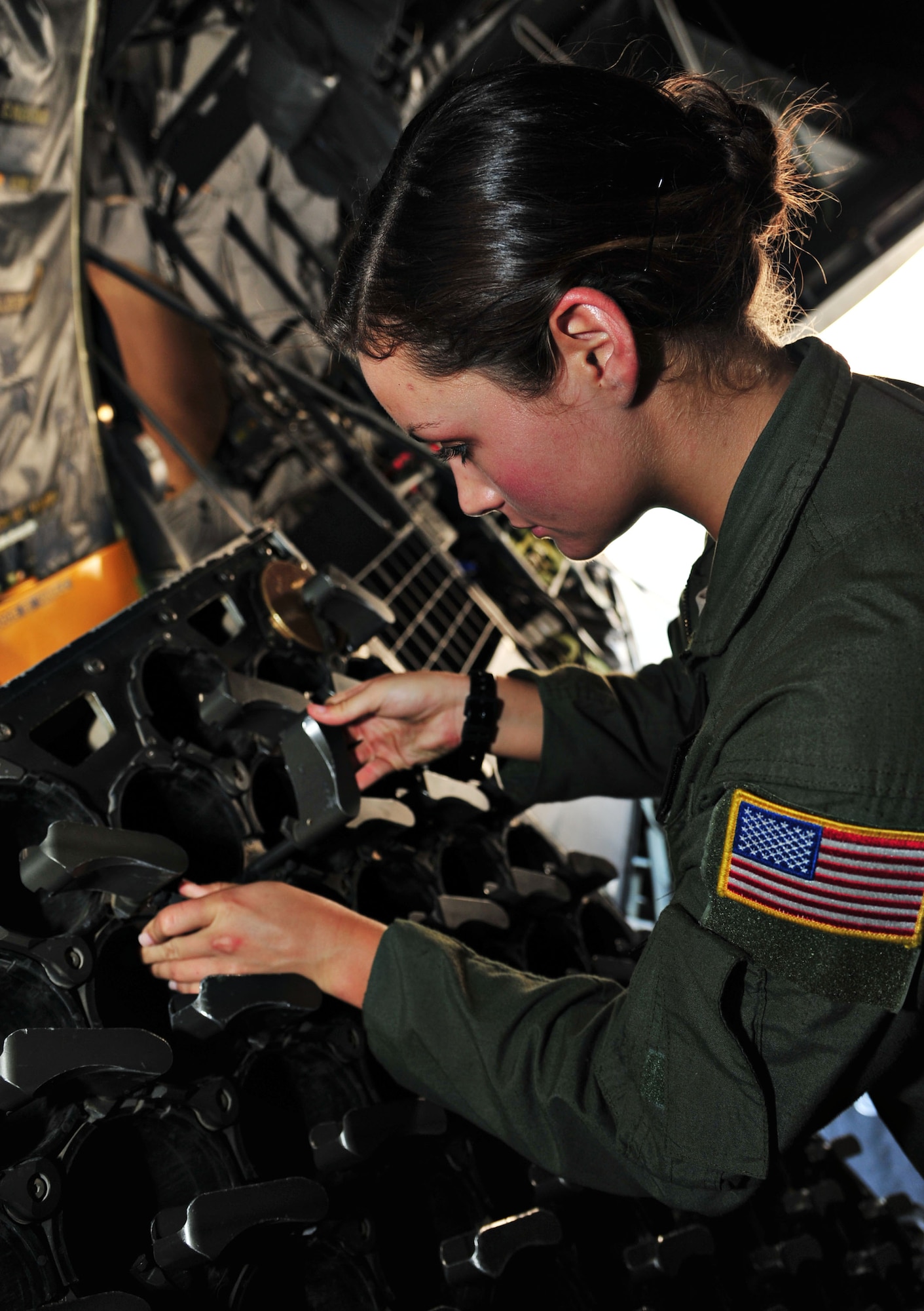 U.S. Air Force Airman First Class Mary Howe, 4th Special Operations Squadron aerial gunner, inspects an AC-130 Spooky Gunship ammunition, storage and handling system for foreign object debris, Hurlburt Field, Fla., June 17, 2013. Howe is the granddaughter of retired Army Col. Charles Beckwith who is credited with the creation of the U.S. Army's Delta Force, which in turn paved the way for the special operations we know today. (U.S. Air Force photo by Senior Airman Desiree Whitney Moye)