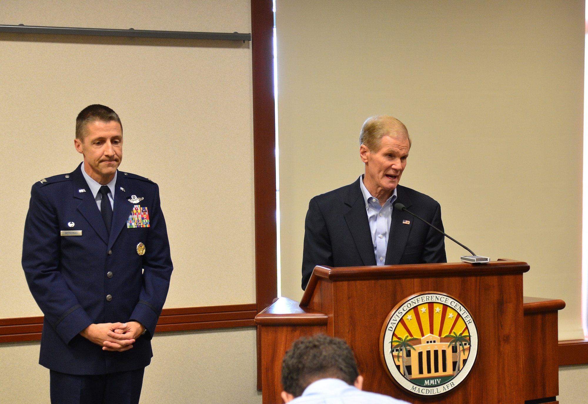 Bill Nelson, U.S. Senator for the state of Florida, and Col. Scott DeThomas, 6th Air Mobility Wing commander, speak with community and media members about security of the installation at MacDill Air Force Base, Fla. July 12, 2013. Nelson visited the base to investigate how security was breached and what had been done to fix it. (U.S. Air Force photo by Senior Airman Adam Grant/Released/cropped for point of interest)