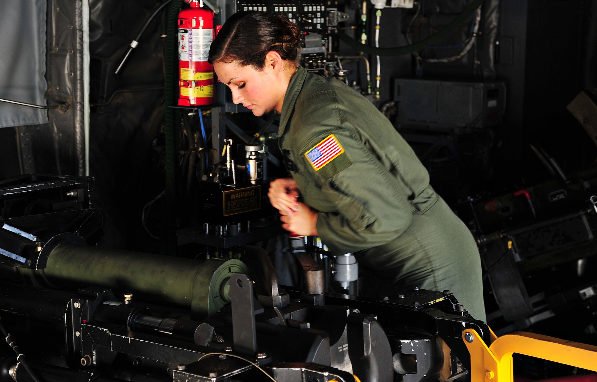 U.S. Air Force Airman First Class Mary Howe, 4th Special Operations Squadron aerial gunner, rotates an AC-130 Spooky Gunship breech operating handle, ensuring accurate assembly on the flightline at Hurlburt Field, Fla., June 17, 2013. Howe is the granddaughter of retired Army Col. Charles Beckwith who is credited with the creation of the U.S. Army's Delta Force. (U.S. Air Force photo by Senior Airman Desiree Whitney Moye)
