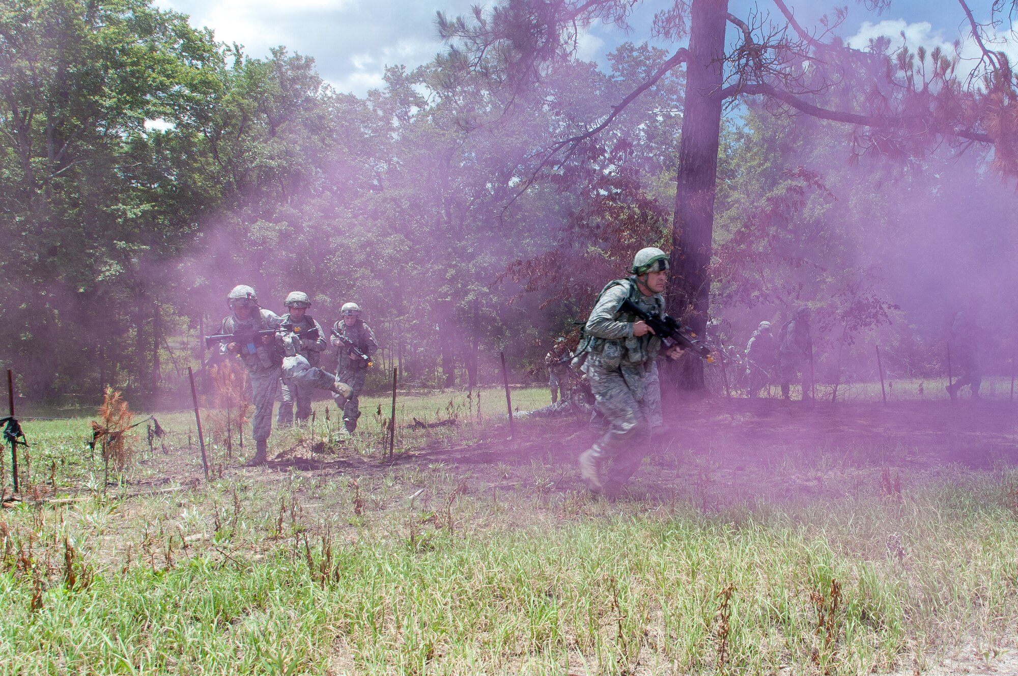 Members of the 165th Security Forces Squadron charge toward a building during a combat training scenario, June 1, 2013, at Ft. Stewart?s Military Operations in Urban Terrain (MOUT) site in Hinesville, Ga. During the four-day exercise, the unit conducted daylight and night time operations for 15 hours per day with Airmen carrying over 50 lbs. of body armor, ammunition, and weapons. Personnel engaged in scenarios ranging from active shooter incidents to casualty evacuations. (U.S. Air National Guard photo by Staff Sgt. Noel Velez-Crespo/released)