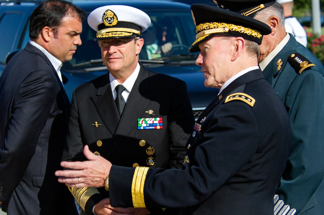 U.S. Army Gen. Martin E. Dempsey, chairman of the Joint Chiefs of Staff, center, welcomes Mexican leaders army Gen. Salvador Cienfuegos Zepeda, right, defense secretary, and navy Adm. Vidal Francisco Soberón Sanz, center, navy secretary, for the U.S.-Mexico Defense Chiefs Strategy Dialogue at the National Defense University on Fort McNair in Washington, D.C., July 15, 2013.