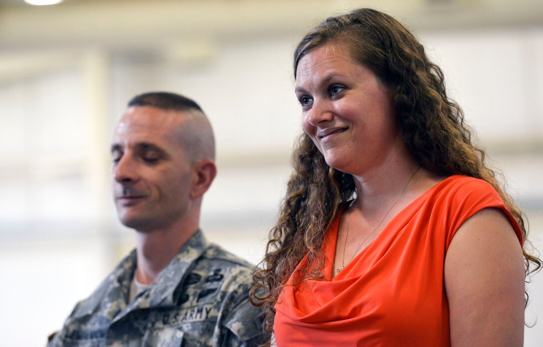 Melissa Lewandowski smiles as she, her husband, Army 1st Sgt. Evan Lewandowski, and their three children receive recognition as "Family of the Year" on Fort Bragg, N.C., July 15, 2013, during Defense Secretary Chuck Hagel's visit to the base.
