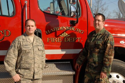 SSgt. Thomas Moses and SSgt. Jason Scharf of the Kentucky Air National Guard's 123rd Airlift Wing stand by a firetruck from the Hardinsburg City Fire Department. Earlier today, the Airmen along with local authorities from the fire department saved an elderly couple from carbon monoxide poisoning during a door-to-door wellness check in the Breckenridge county community.