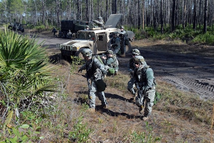 Soldiers from Company B, 1st Battalion, 128th Infantry Regiment, 32nd Infantry Brigade Combat Team dismount from their vehicle during a convoy training exercise at Camp Blanding Joint Training Center in Florida. The 32nd is conducting training in preparation for an upcoming deployment to Iraq.