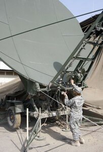 SPC Belinda Arblaster (C/146th) performs Preventative Maintenance Checks and Services (PMCS) on a Lightweight High Gain X-Band (LHGXA) Satellite Antenna supporting a Phoenix Satellite System at Victory Base Camp.